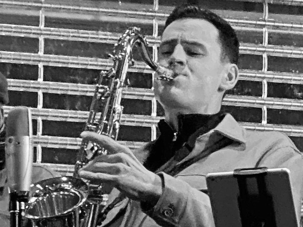 Man playing tenor saxophone close up