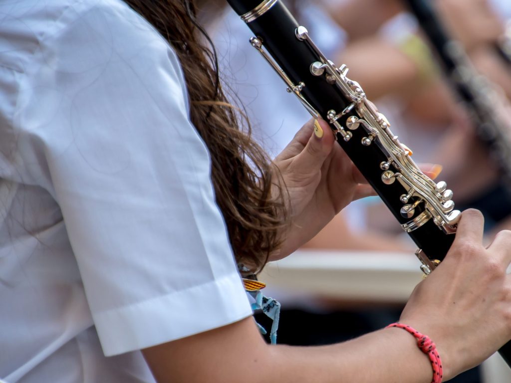Close up of young person playing clarinet