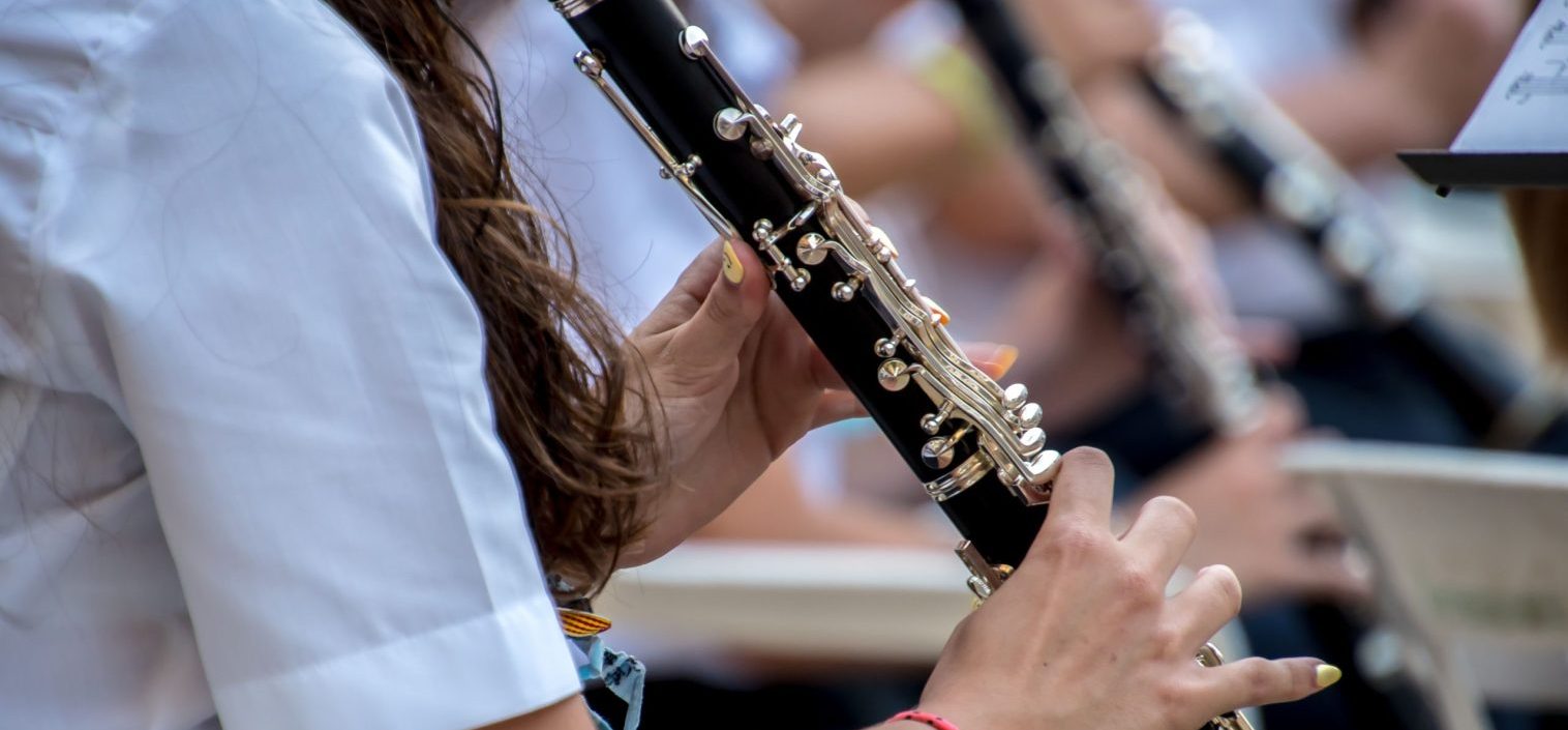 Close up of young person playing clarinet